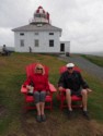 Eloise and Livingston sit in front of the old lighthouse